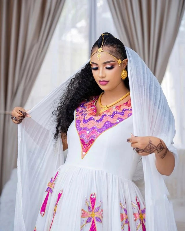 Enchanting Habesha wedding dress radiates vibrant beauty with its array of colors and intricate details