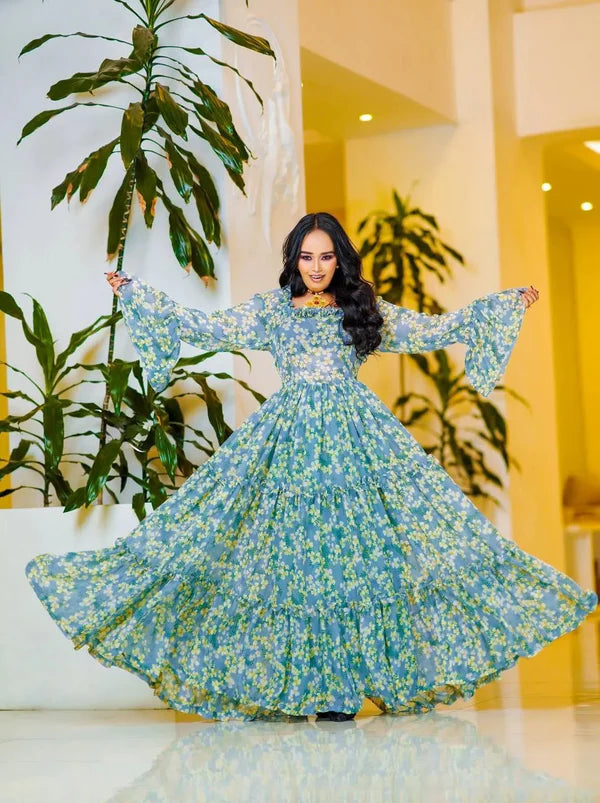 A lovely light blue Habesha chiffon dress with yellow embellishments is perfect for any occasion.