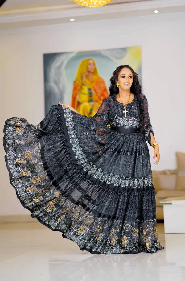 A chic black Habesha chiffon dress with silver and gold detailing