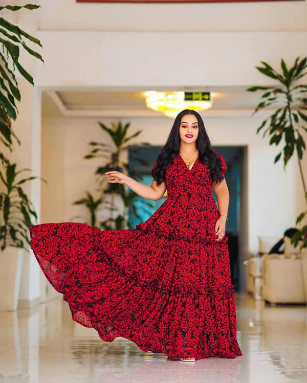 This striking red Habesha dress features elegant black embellishments.