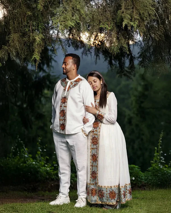 Fondling Love in Light Blue Habesha Couples Outfit: Golden Circular Detailing for a Matching Look