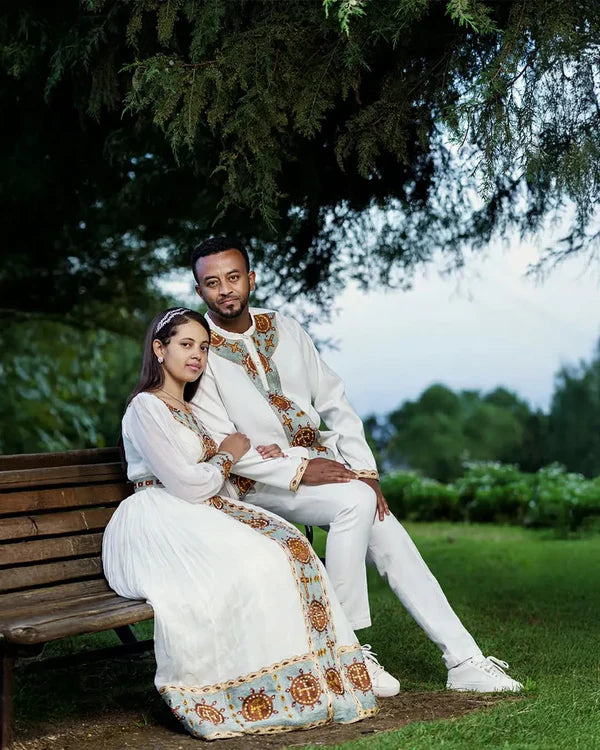 Fondling Love in Light Blue Habesha Couples Outfit: Golden Circular Detailing for a Matching Look