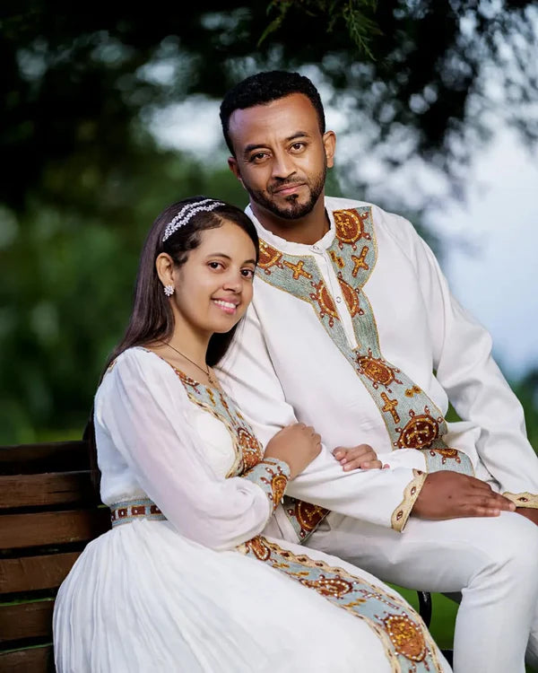 Fondling Love in Light Blue Habesha Couples Outfit: Golden Circular Detailing for a Matching Look