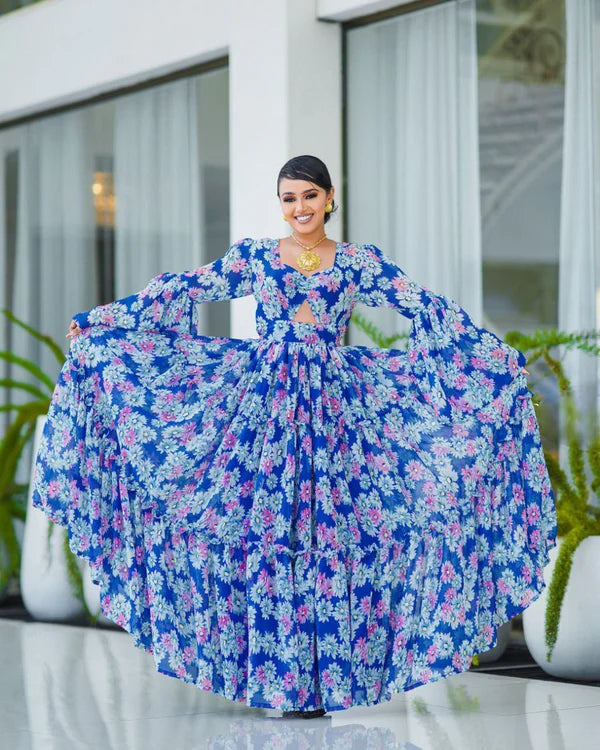A stunning blue Habesha chiffon dress with a cutout design and pink floral accents.
