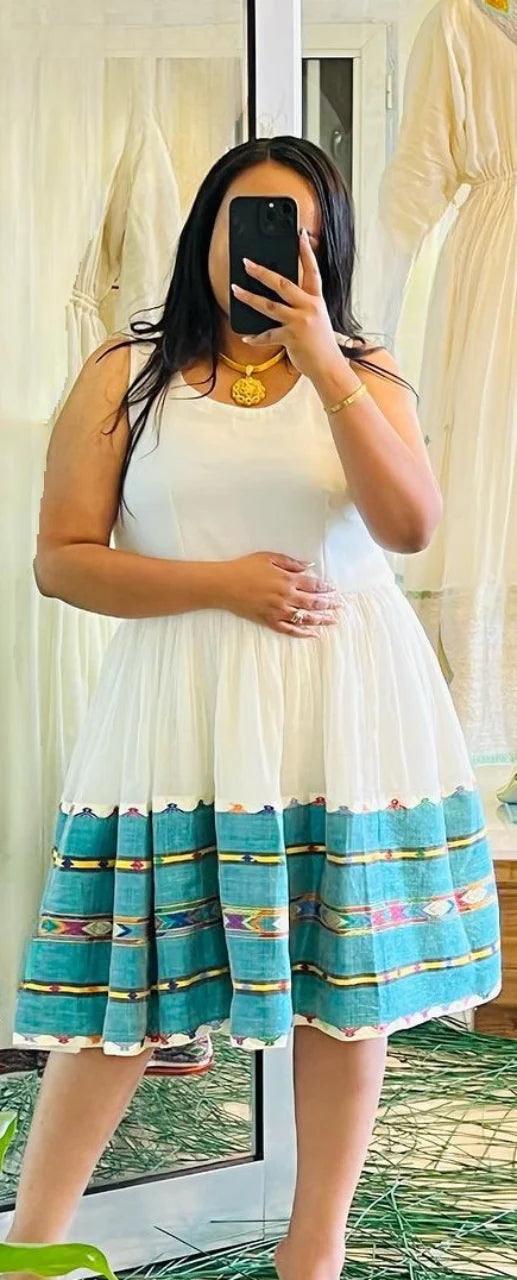 A vibrant green mini-dress in the style of a Habesha Kemis offers a contemporary take on traditional clothing