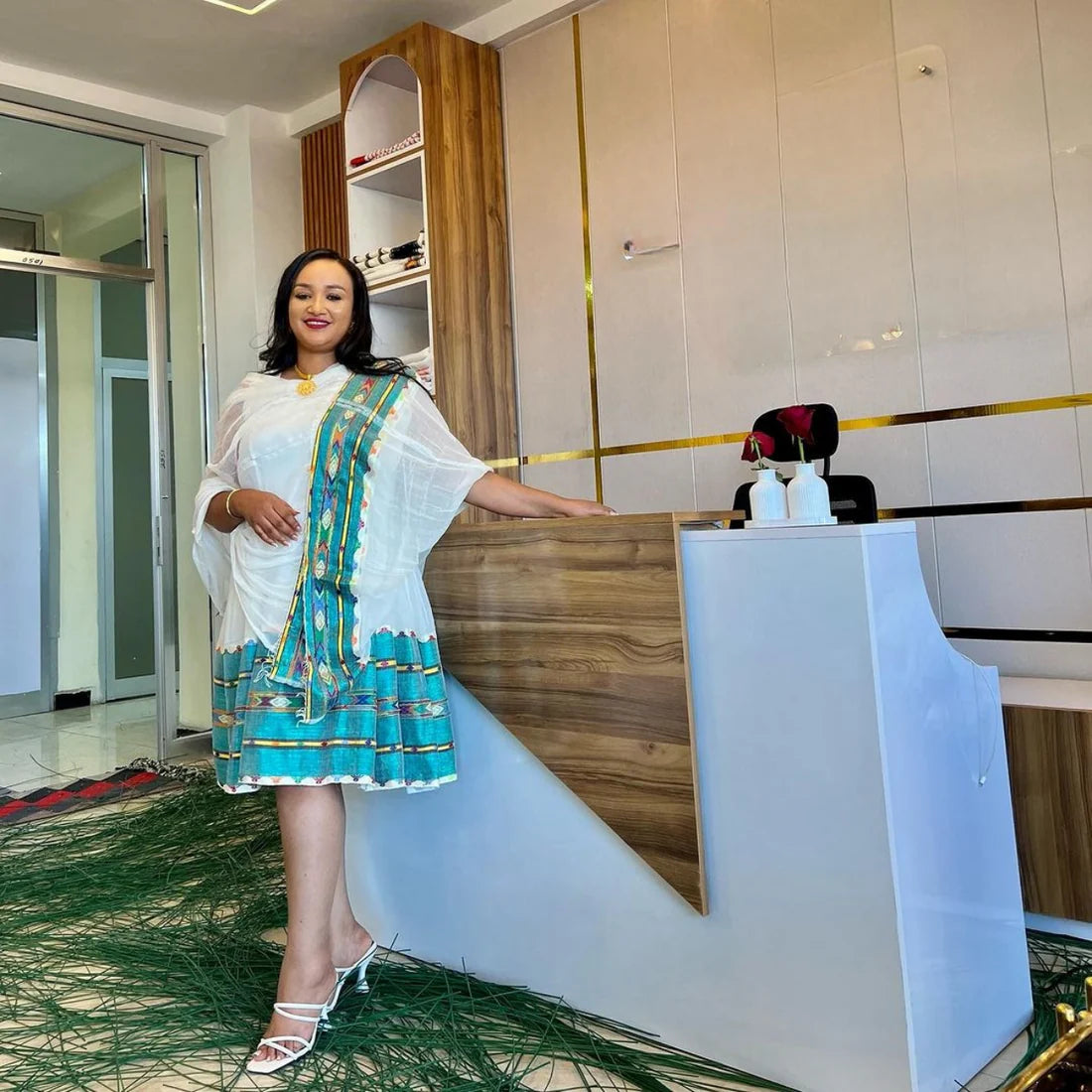 A vibrant green mini-dress in the style of a Habesha Kemis offers a contemporary take on traditional clothing