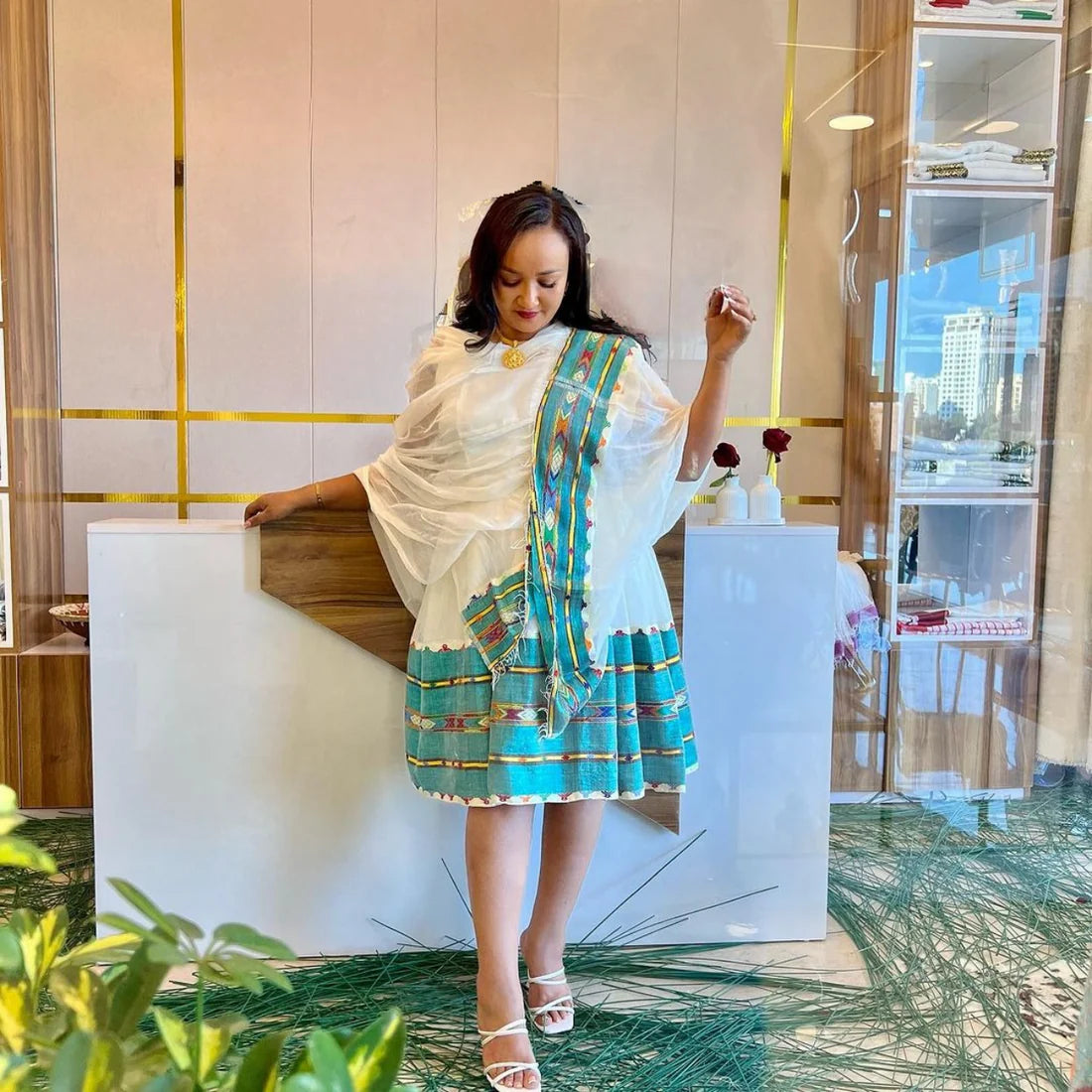 A vibrant green mini-dress in the style of a Habesha Kemis offers a contemporary take on traditional clothing