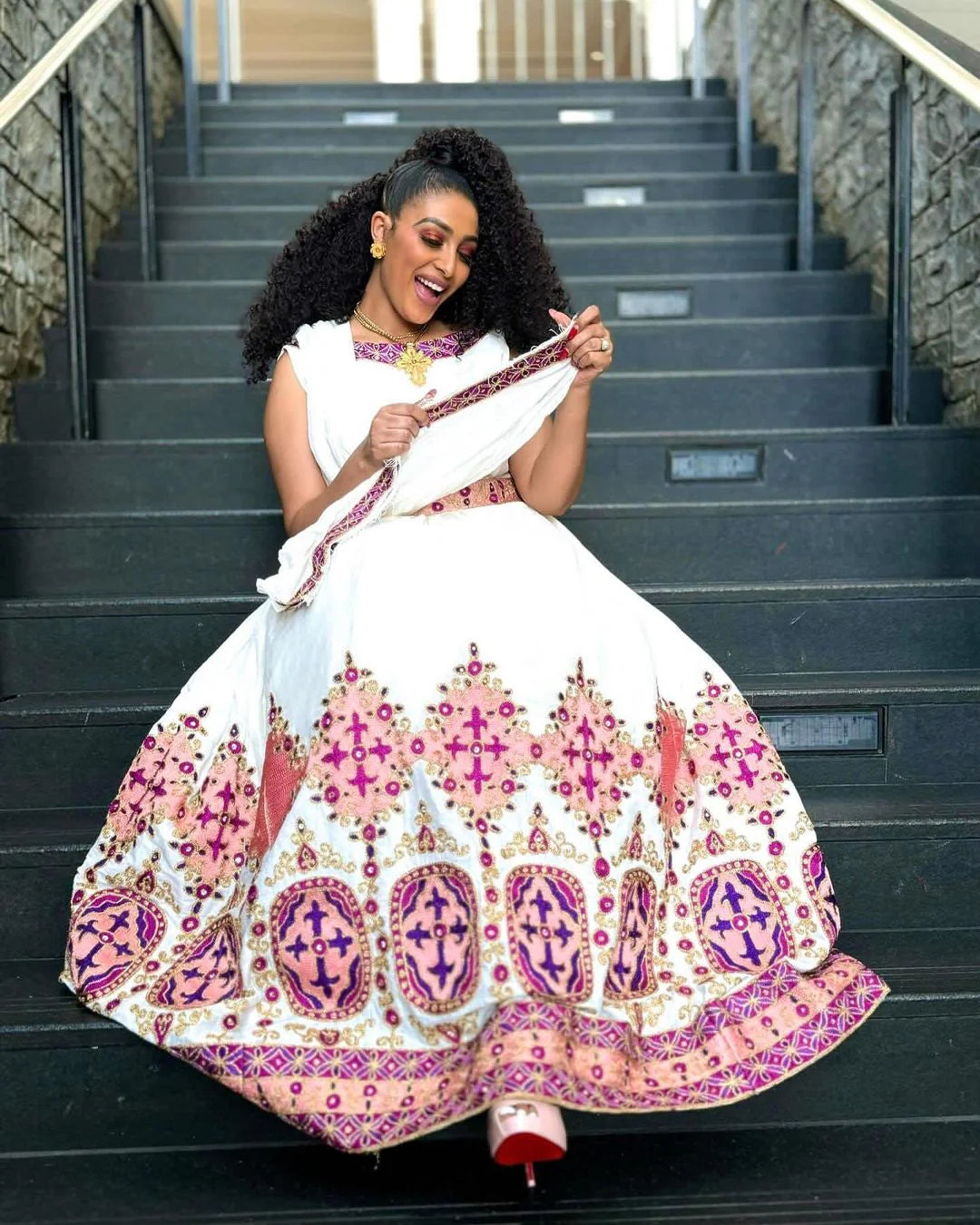 Embrace the Grace of Habesha Attire: Pink and Purple Brilliance in a Modern Gown