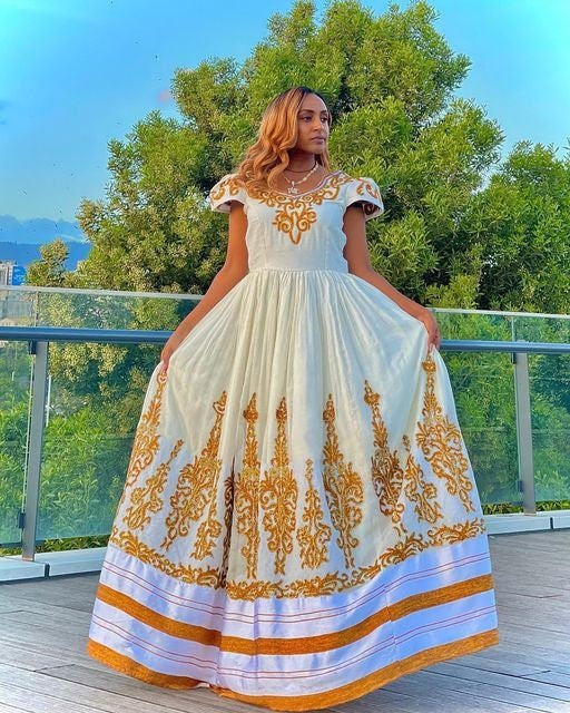 A luxurious full tilf Habesha Wedding kemis crafted from rich Menen fabric