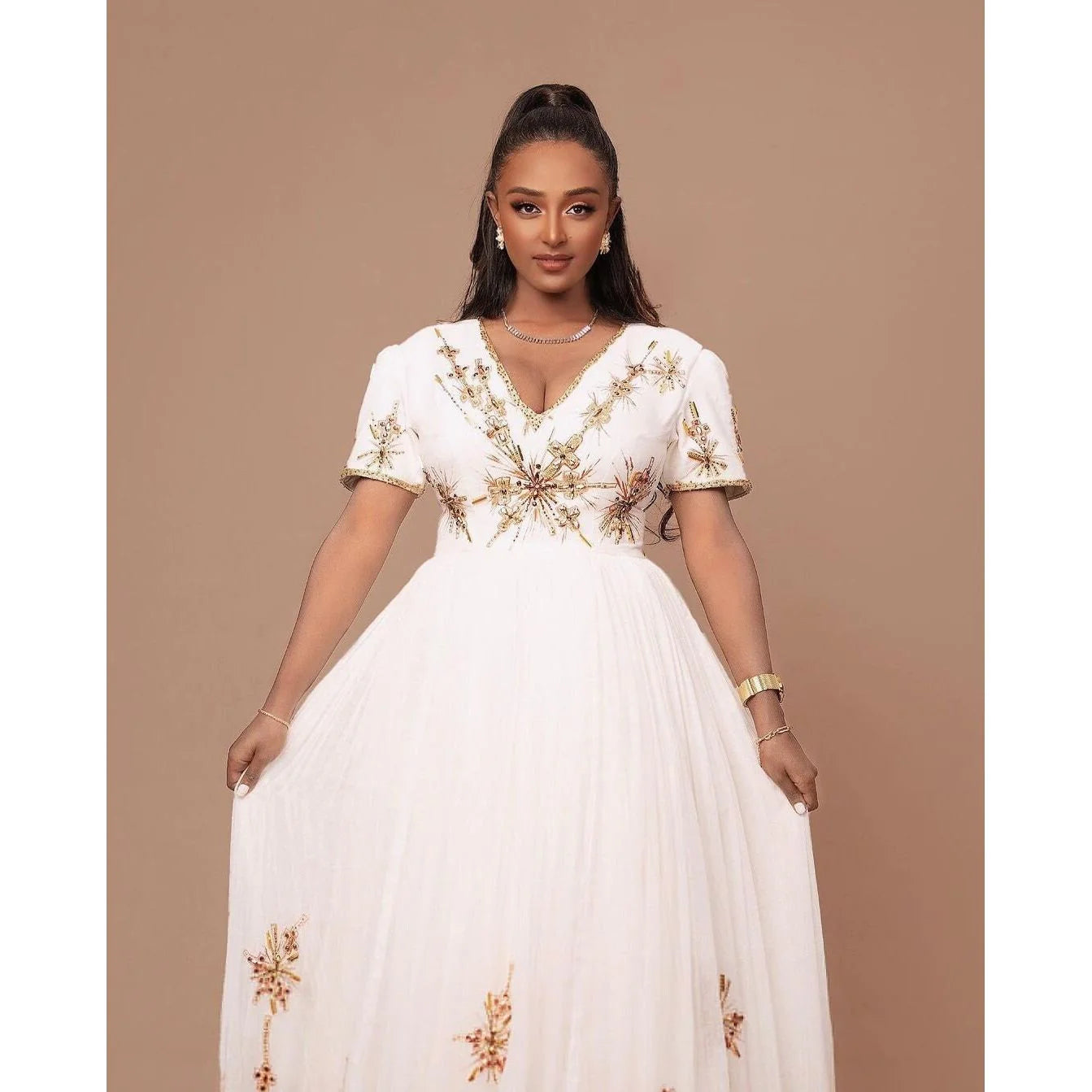 A Habesha Wedding dress in Menen fabric with a Shimena bottom and a white and gold Tilf design