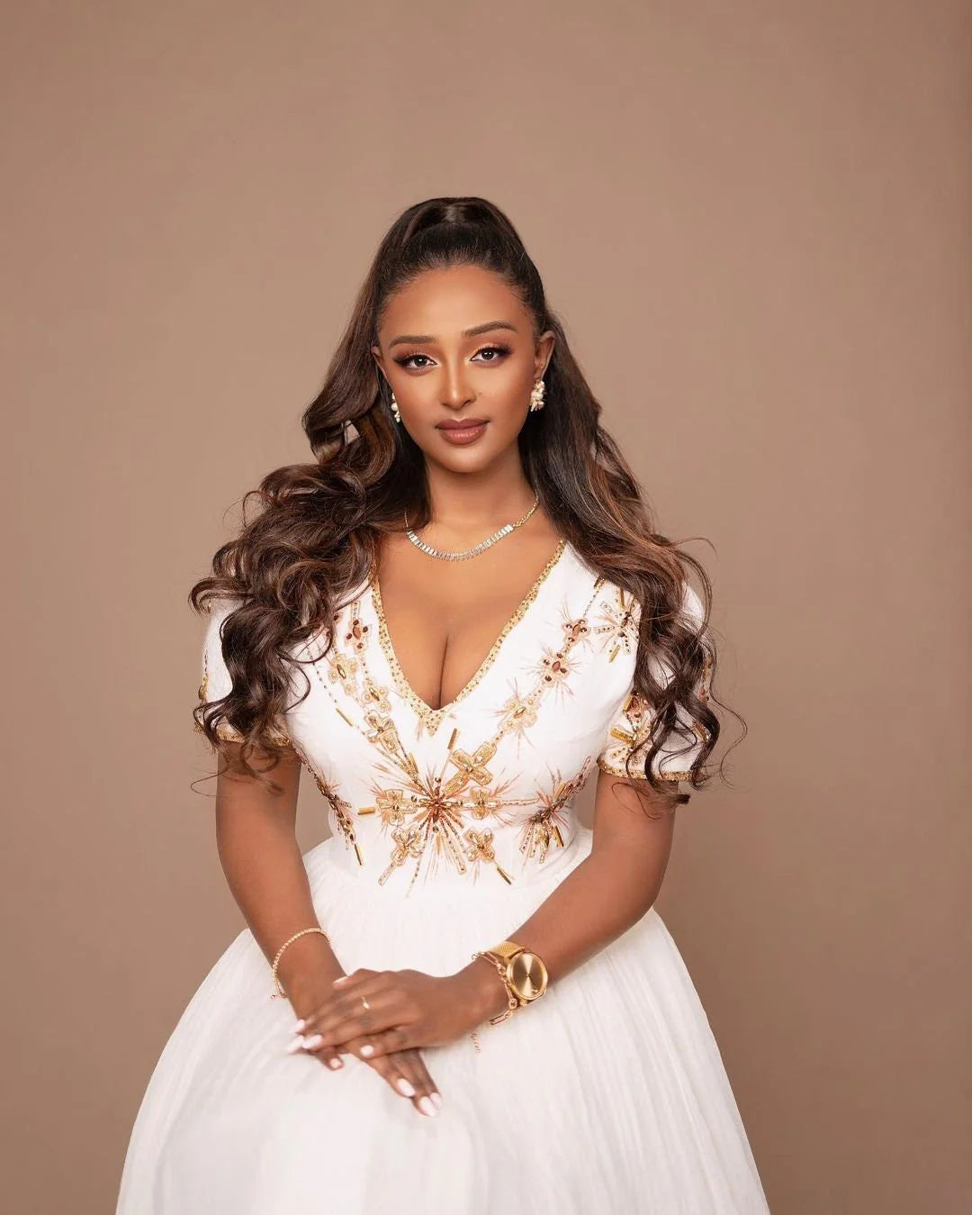 A Habesha Wedding dress in Menen fabric with a Shimena bottom and a white and gold Tilf design