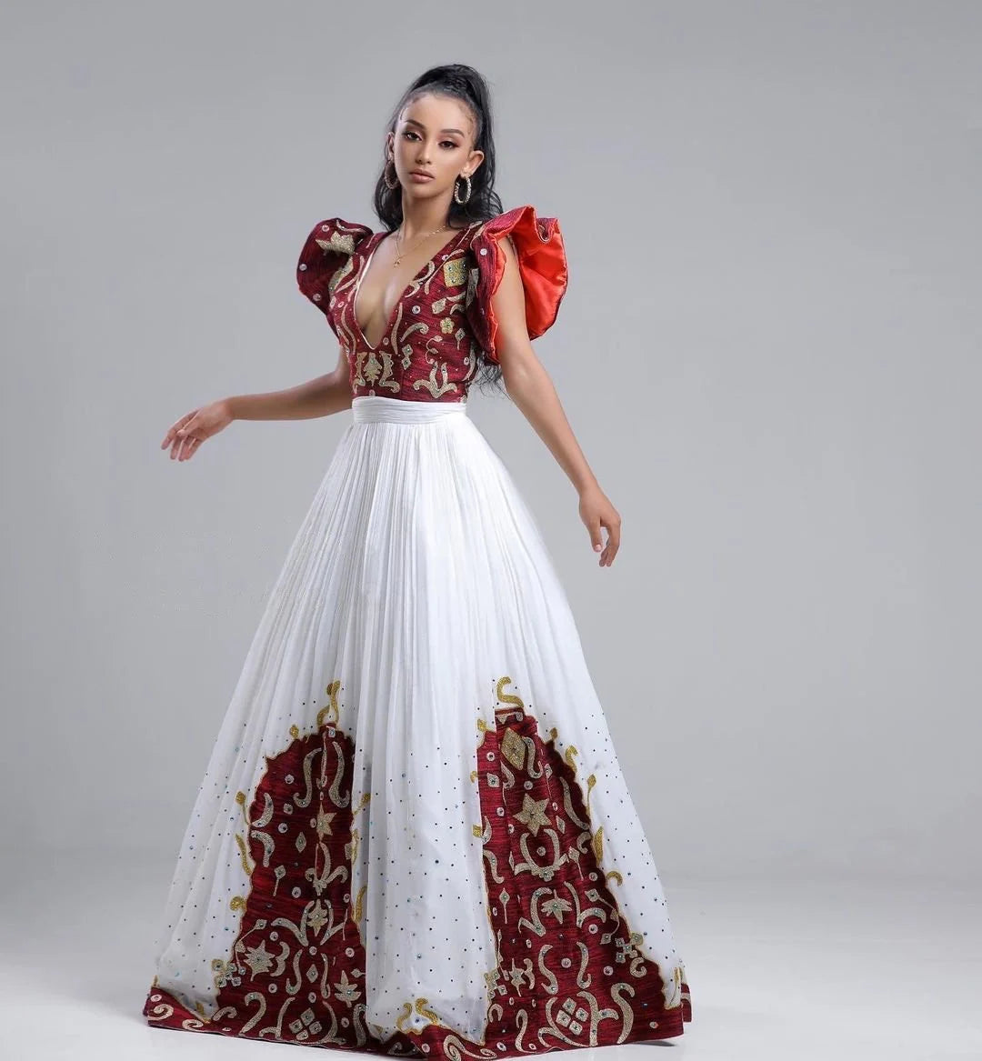 A Habesha Fabric Wedding Kemis with Shimena Top, adorned with beaded accents and a Tilf hem