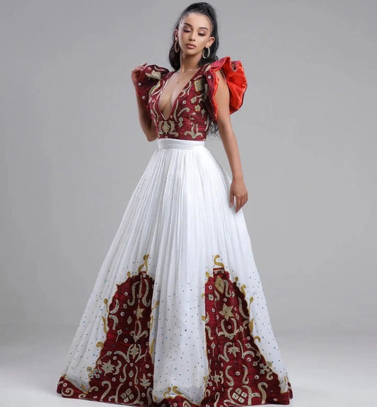 A Habesha Fabric Wedding Kemis with Shimena Top, adorned with beaded accents and a Tilf hem