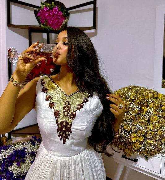 A luminous Habesha gown Gilded accents, modern design. Radiant cultural style