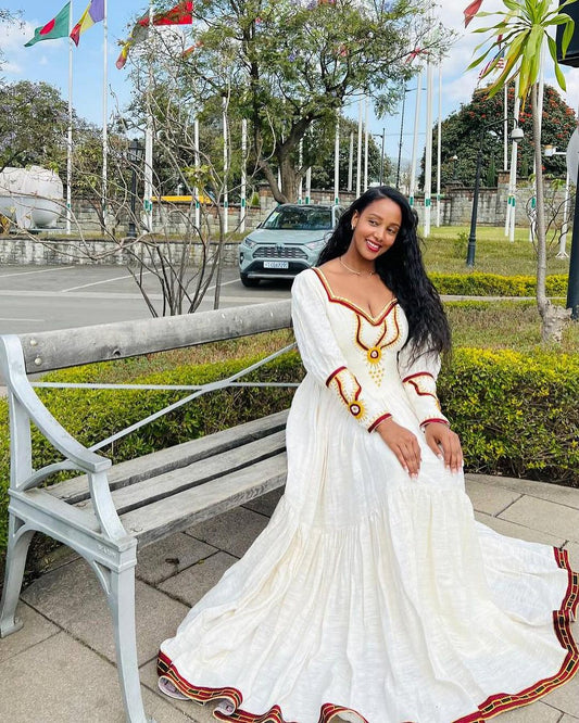A striking Habesha gown bold red hue, unique design Modern cultural flair