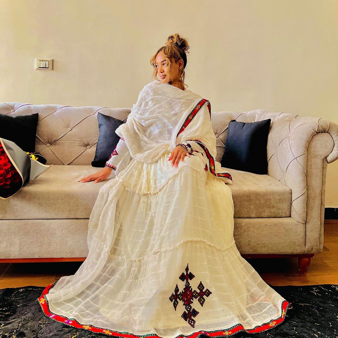 A refined Habesha Kemis: striking red, minimalist design. Modern, effortless cultural style