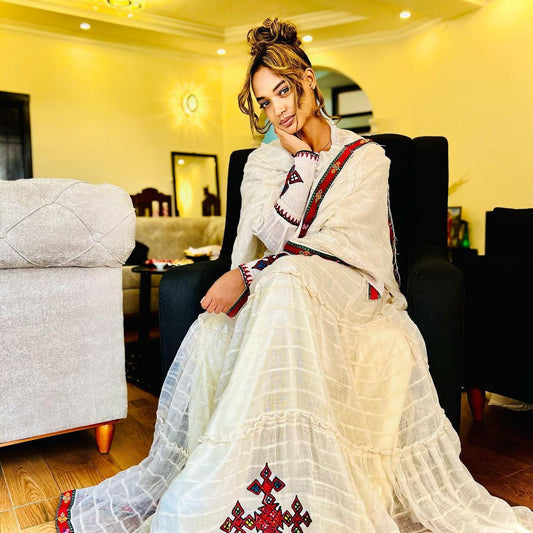 A refined Habesha Kemis: striking red, minimalist design. Modern, effortless cultural style