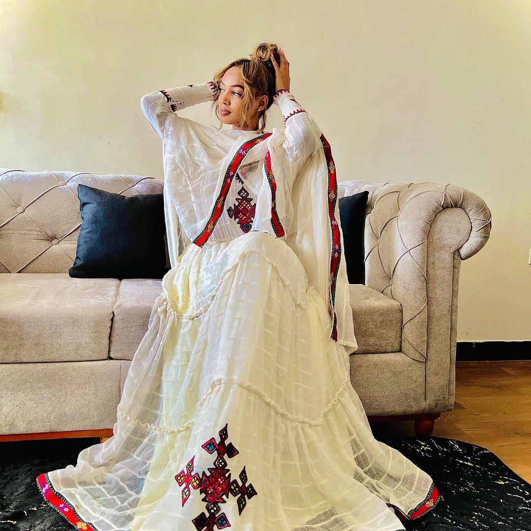 A refined Habesha Kemis: striking red, minimalist design. Modern, effortless cultural style