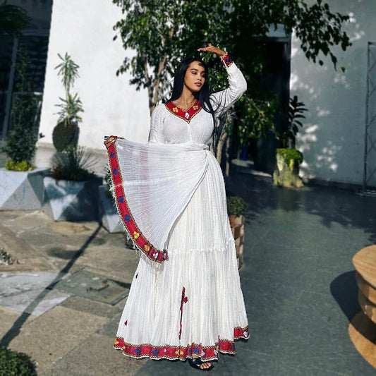 A profound Habesha Kemis: deep crimson hue, sophisticated design, mysterious allure