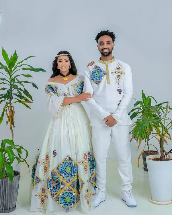Sapphire Serenade: Ethereal Sparkle in Blue Habesha Couples Wedding Attire.