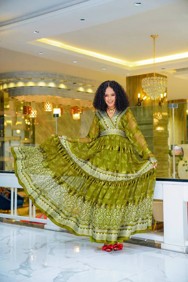A stylish olive green Habesha chiffon dress with a striking pattern.