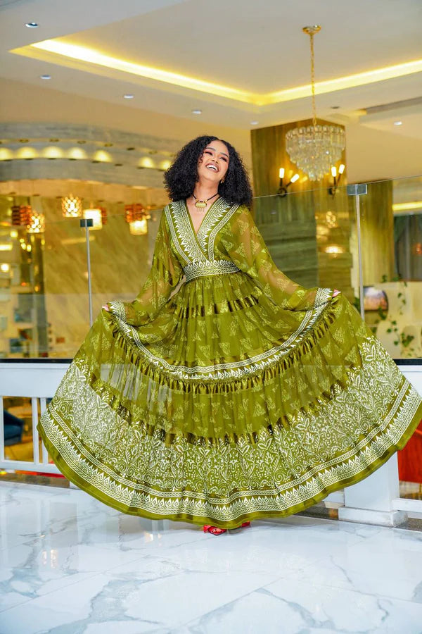 A stylish olive green Habesha chiffon dress with a striking pattern.