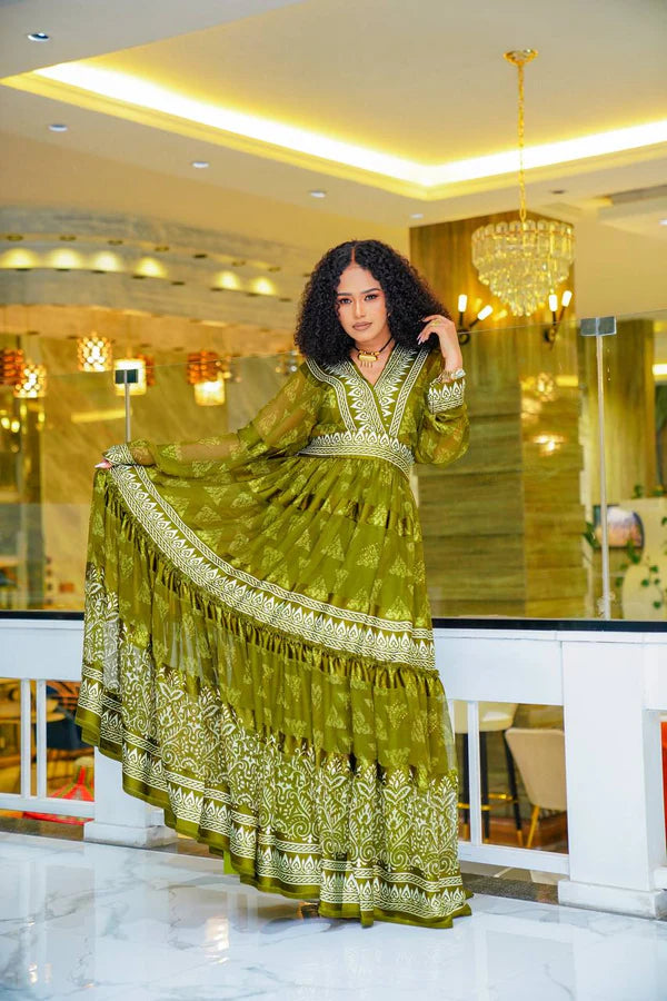 A stylish olive green Habesha chiffon dress with a striking pattern.