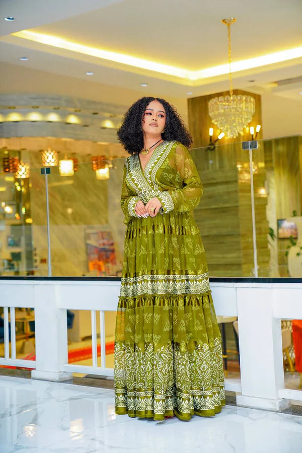 A stylish olive green Habesha chiffon dress with a striking pattern.