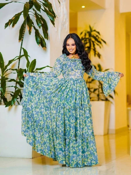 A lovely light blue Habesha chiffon dress with yellow embellishments is perfect for any occasion.