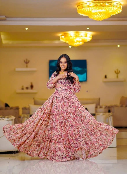 A stylish pink Habesha chiffon dress with cutouts and floral details.