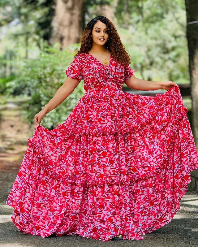This stunning red Habesha chiffon dress is a perfect choice for any special occasion. Its stylish design and luxurious fabric create a truly memorable look.