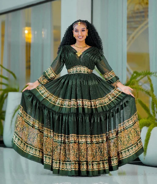 A captivating green Habesha chiffon dress with a gold-embellished hem.