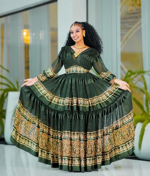 A captivating green Habesha chiffon dress with a gold-embellished hem
