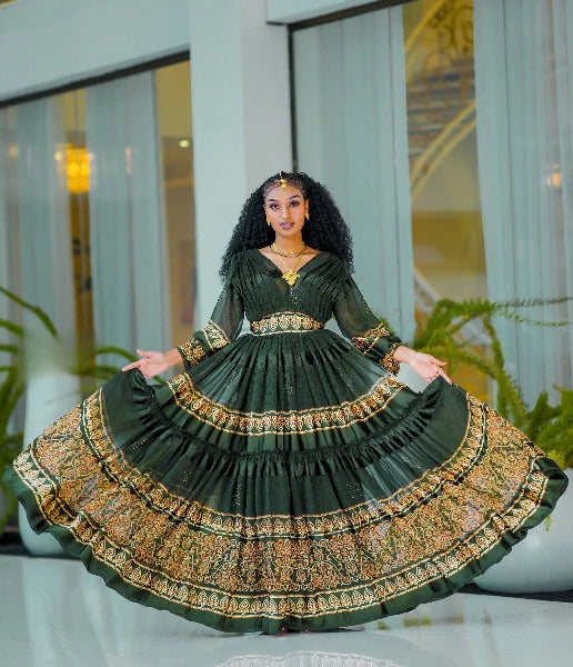 A captivating green Habesha chiffon dress with a gold-embellished hem.