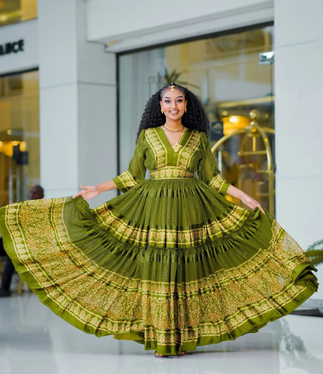 breathtaking light green Habesha chiffon dress, adorned with exquisite golden embellishments, is a truly stunning garment.