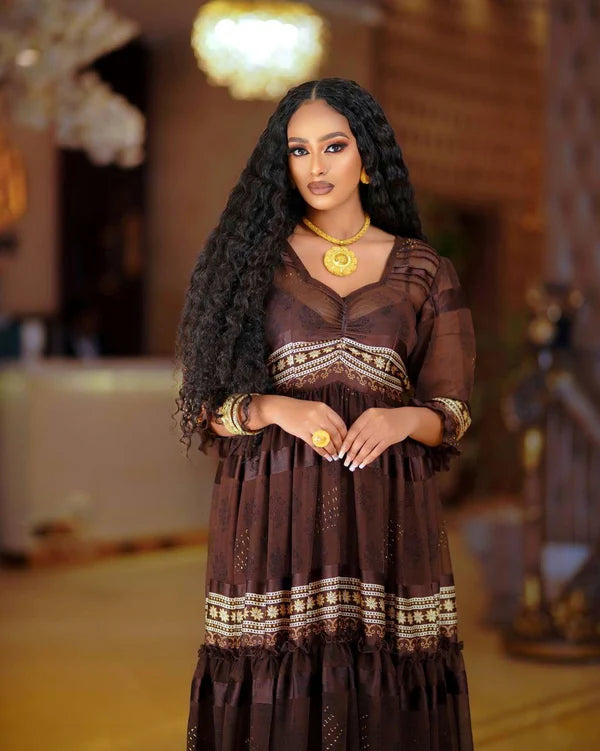A sophisticated dark brown Habesha chiffon dress with a modern design, perfect for cultural and religious celebrations.