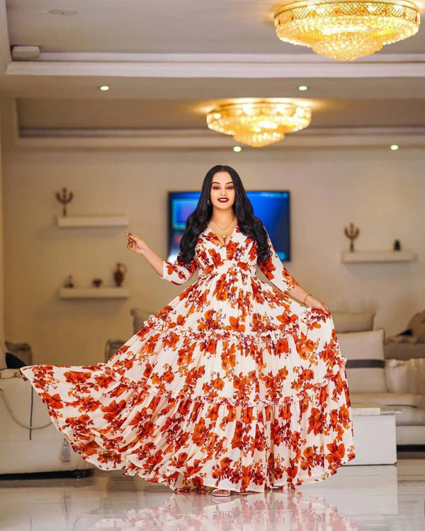 A lovely floral Habesha chiffon dress with red accents.