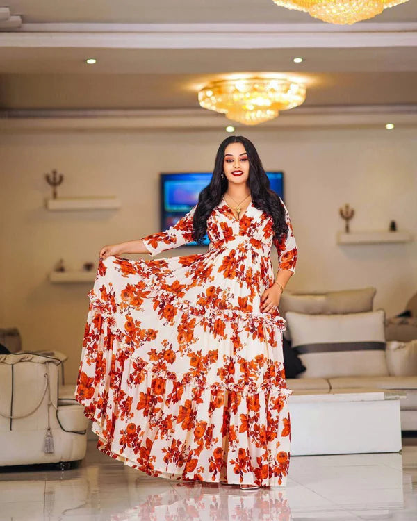 A lovely floral Habesha chiffon dress with red accents.