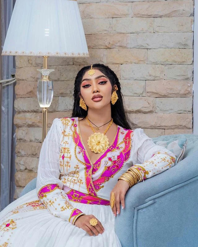 Enchanting Habesha wedding dress radiates beauty and elegance with its captivating pink hue