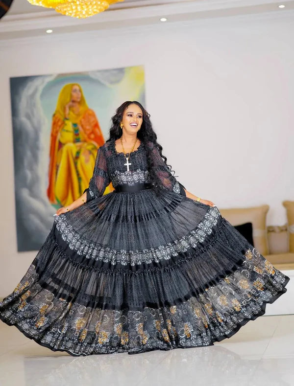 A chic black Habesha chiffon dress with silver and gold detailing
