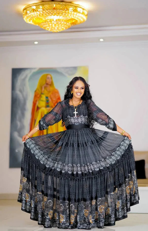 A chic black Habesha chiffon dress with silver and gold detailing