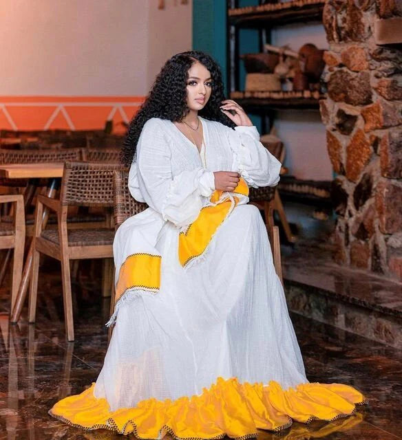 Sunshine in Menen Textile A Gleaming Golden Habesha Dress