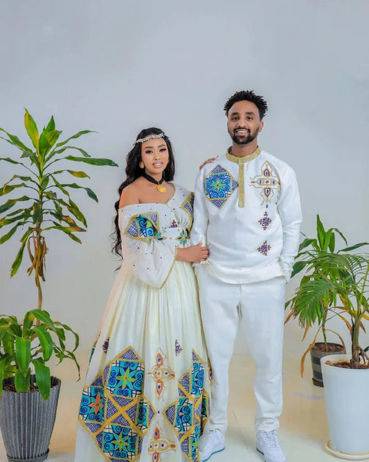 Sapphire Serenade: Ethereal Sparkle in Blue Habesha Couples Wedding Attire.