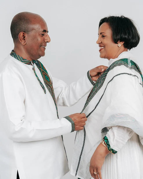 Enchanting Habesha Wedding Attire: Couples' Resplendent Green-Patterned Elegance.