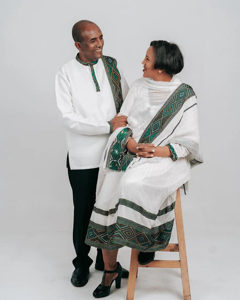 Enchanting Habesha Wedding Attire: Couples' Resplendent Green-Patterned Elegance.
