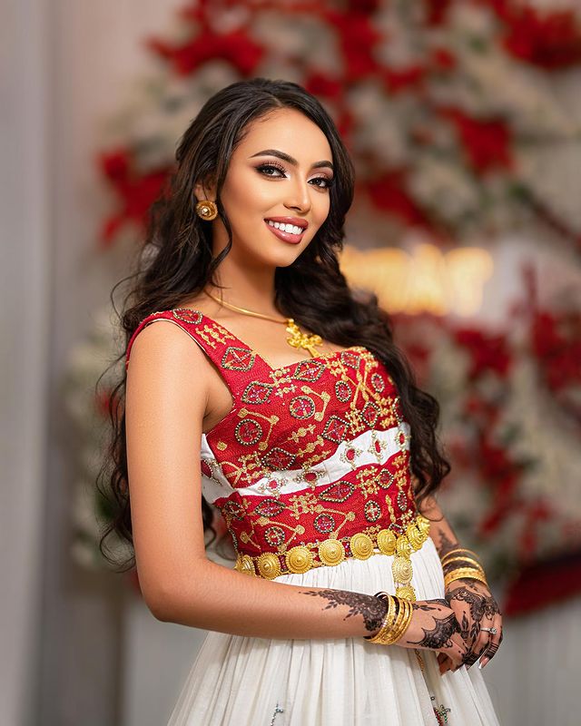 Captivating Habesha wedding dress radiates elegance and beauty with its vibrant red design
