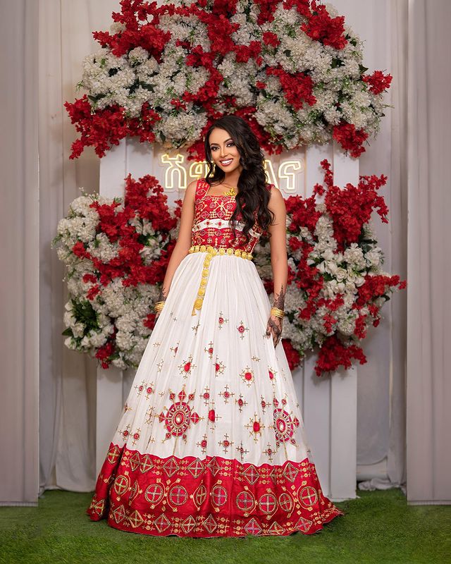Captivating Habesha wedding dress radiates elegance and beauty with its vibrant red design