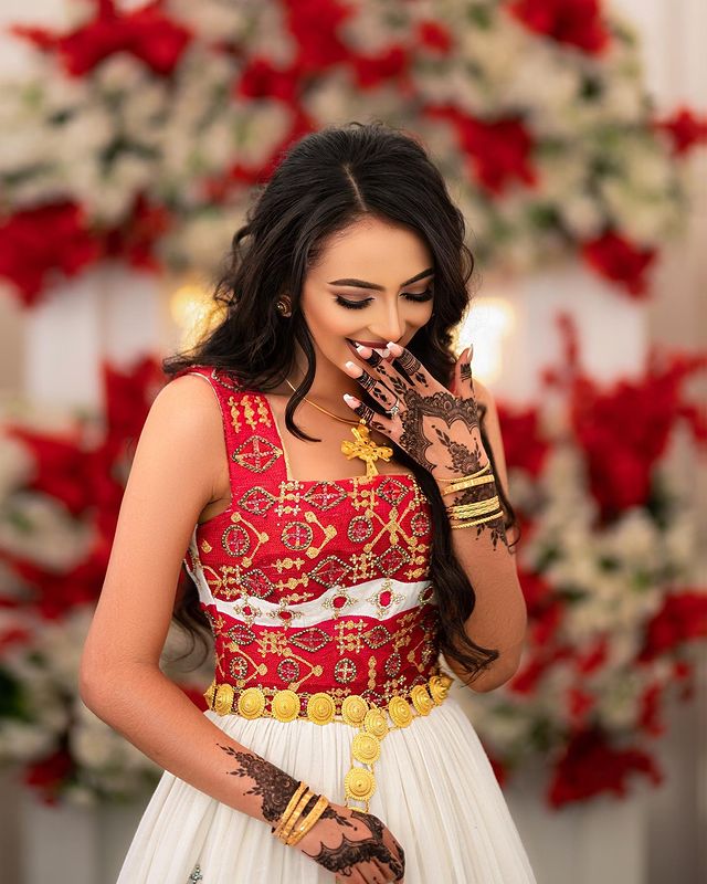 Captivating Habesha wedding dress radiates elegance and beauty with its vibrant red design