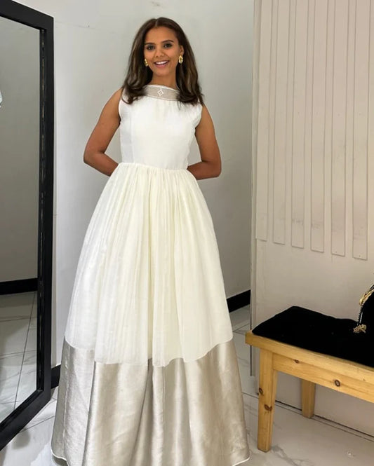 A Silver Habesha Dress with a Wide Hemline, Easy Flair in this Habesha Traditional Kemis