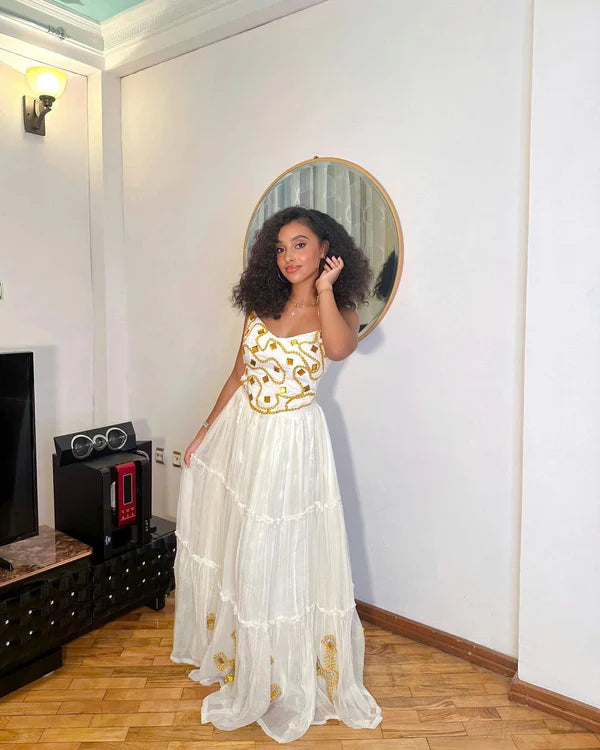 Comfortable Habesha dress features a simple design and beautiful beading.